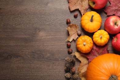 Photo of Thanksgiving day. Flat lay composition with pumpkins on wooden table, space for text