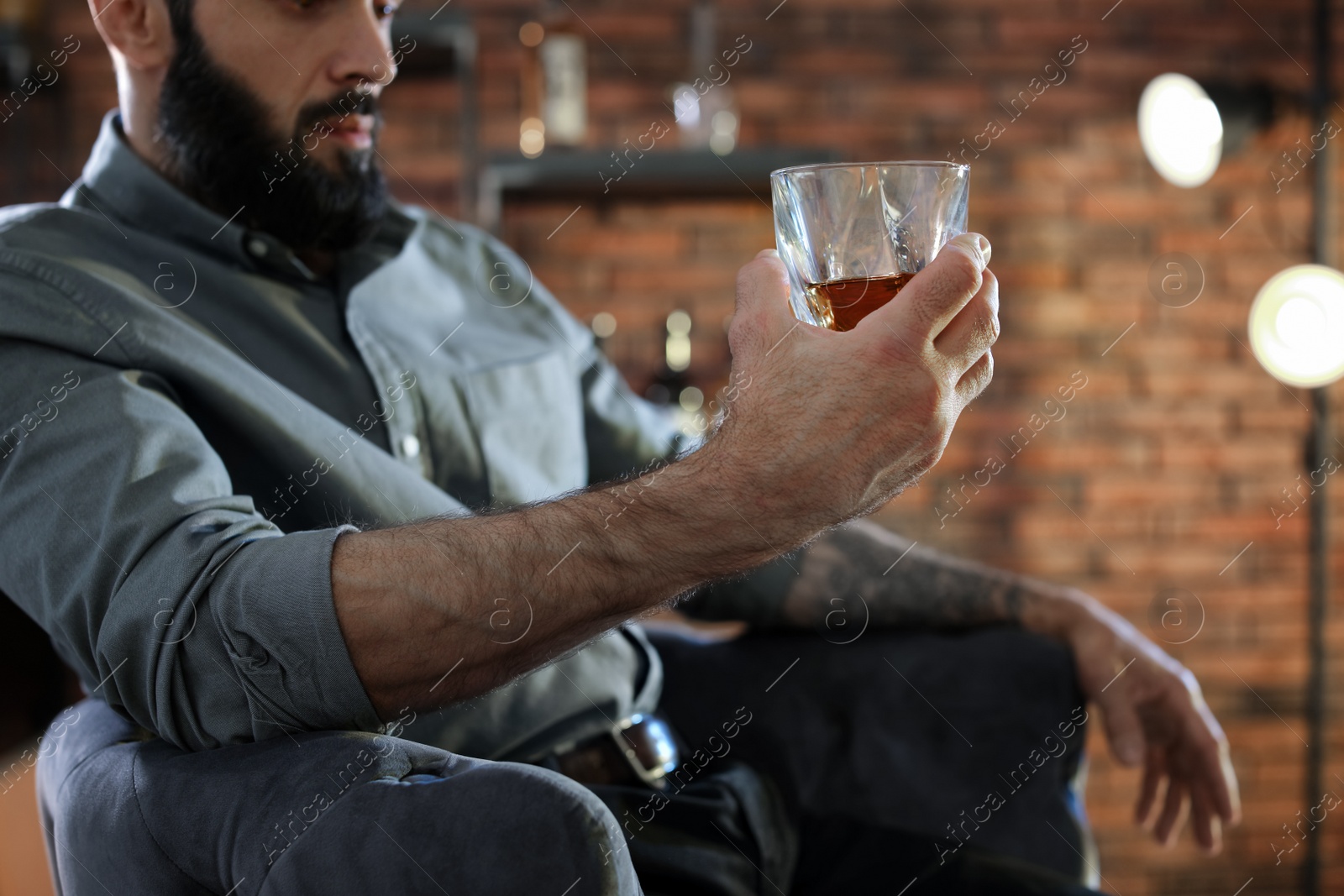 Photo of Man with glass of whiskey indoors, closeup