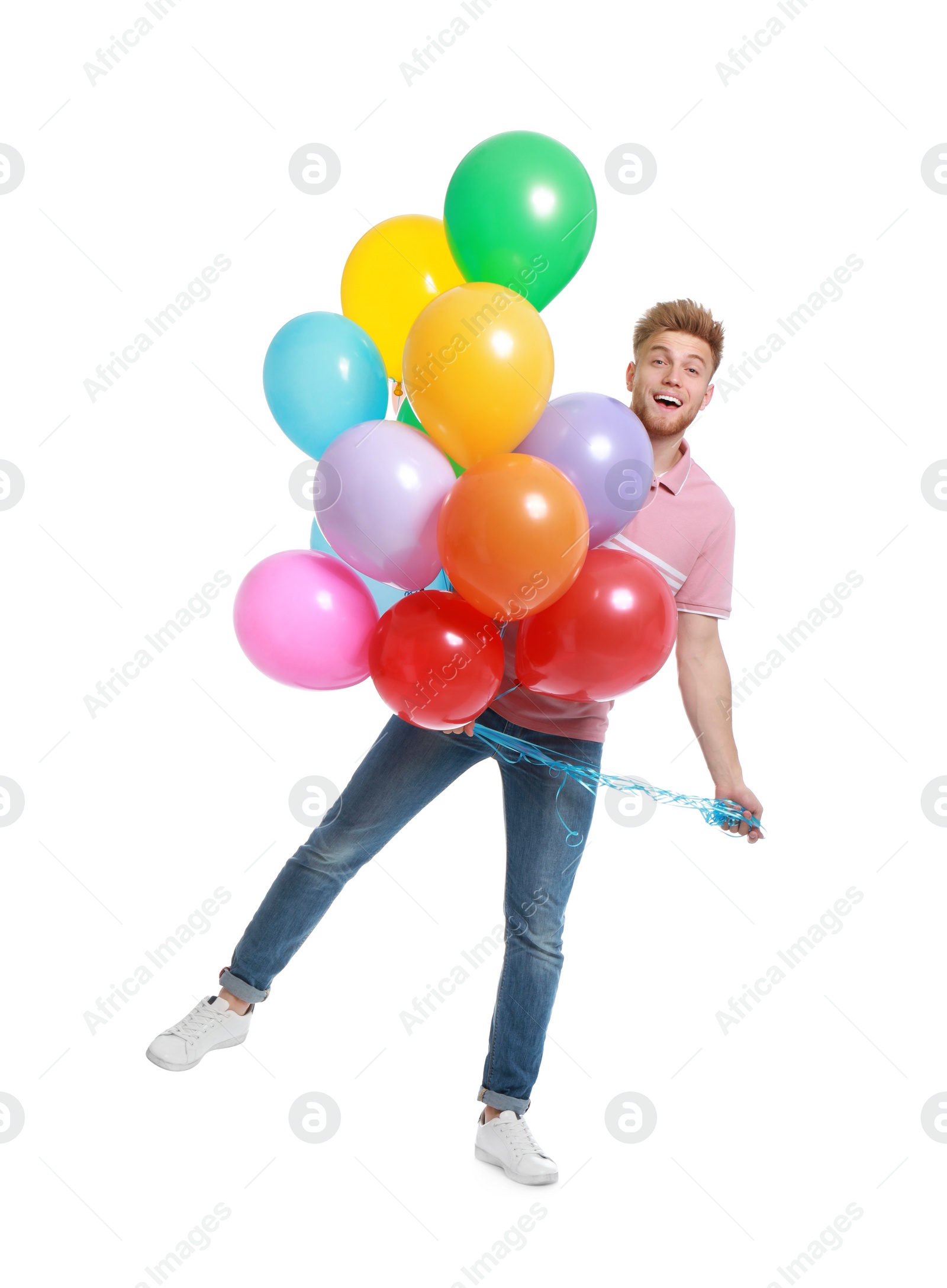 Photo of Emotional young man holding bunch of colorful balloons on white background