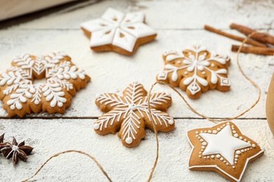 Delicious homemade Christmas cookies and flour on wooden table, closeup