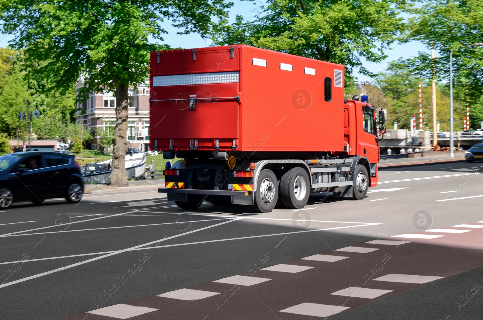 Photo of Modern red fire truck on city street