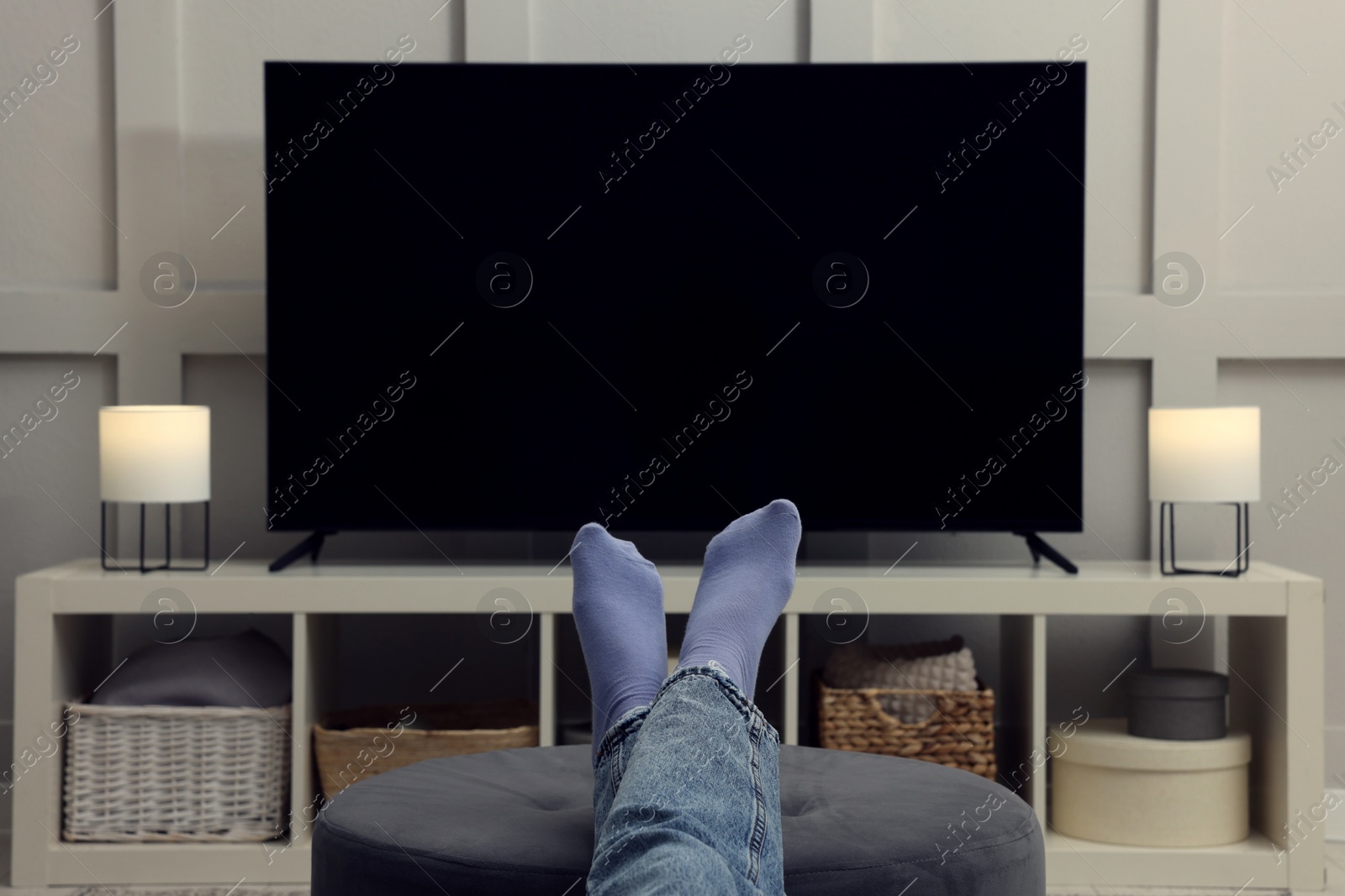 Photo of Woman watching TV in living room, closeup