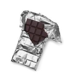 Photo of Delicious dark chocolate bar on white background, top view