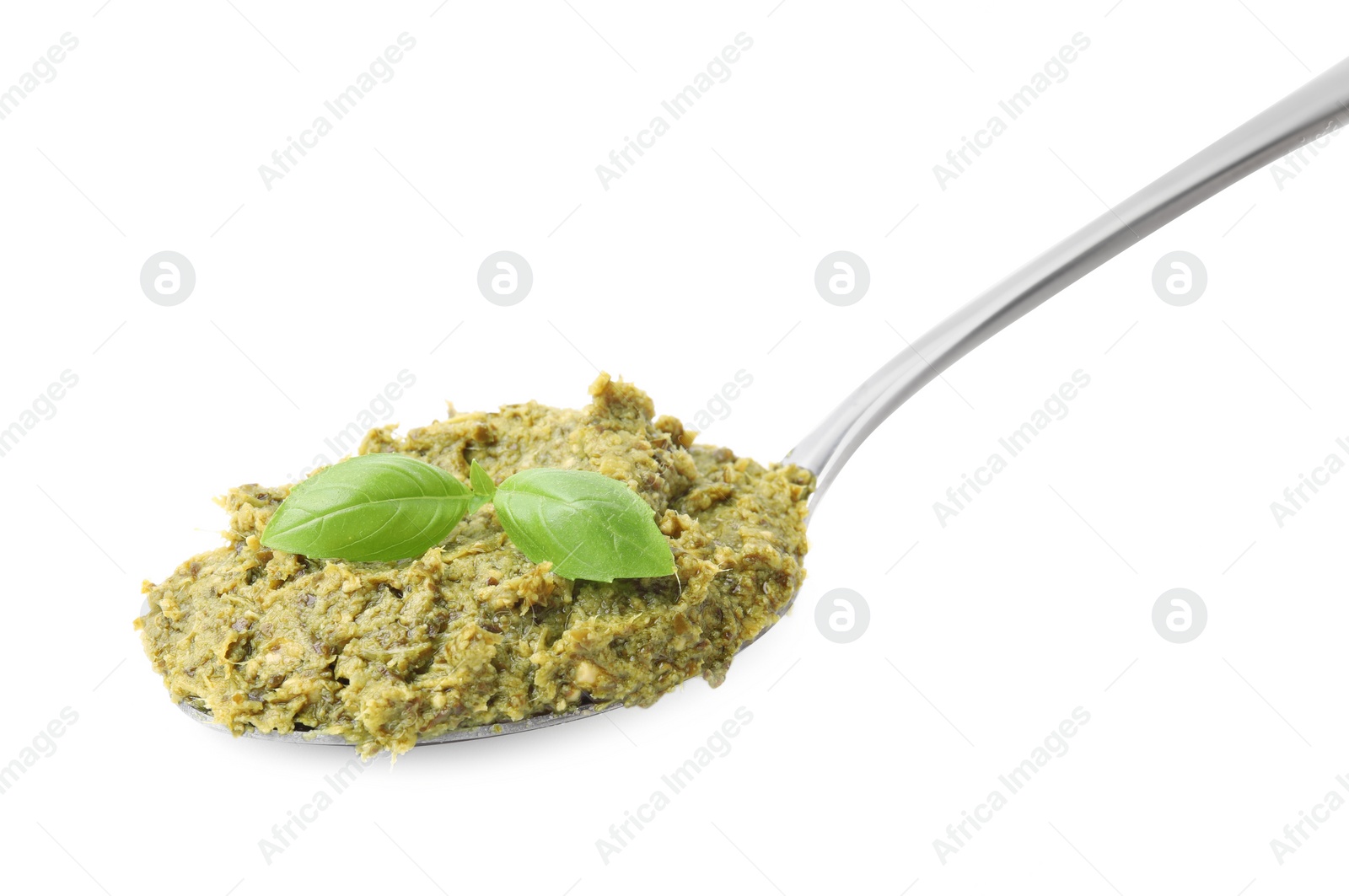 Photo of Spoon with delicious pesto sauce and basil isolated on white