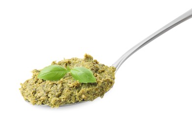Spoon with delicious pesto sauce and basil isolated on white