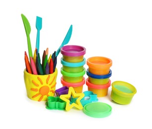 Set of bright play dough with tools and colorful pencils on white background