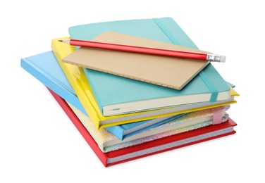 Photo of Stack of different colorful hardcover planners and pencil on white background