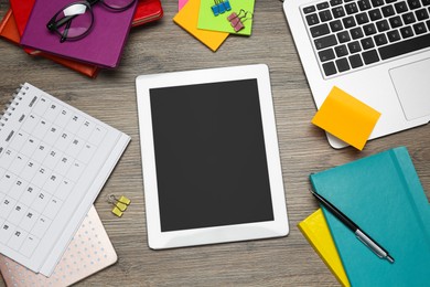 Photo of Modern gadgets and office stationery on wooden table, flat lay. Distance learning