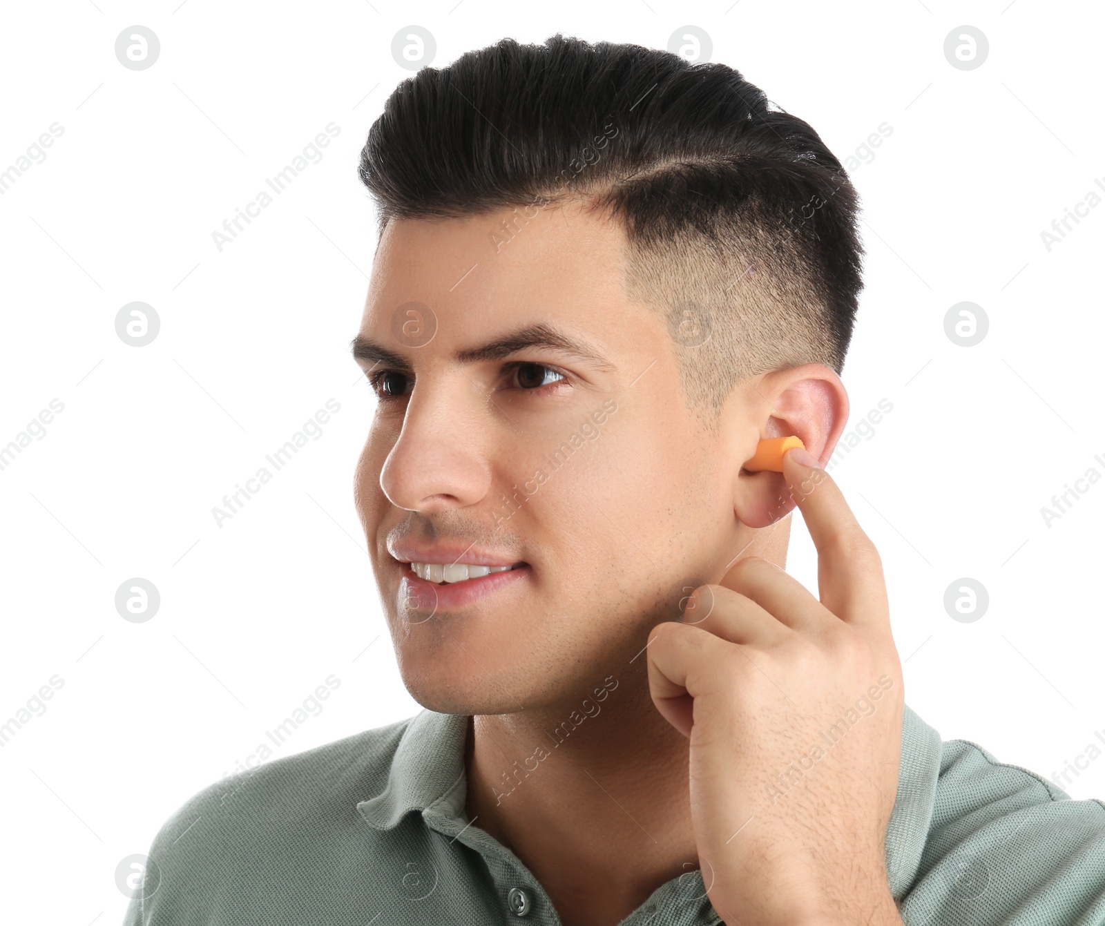 Photo of Man inserting foam ear plug on white background