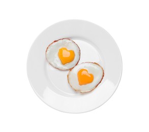 Image of Plate with tasty fried eggs with yolks in shape of heart on white background, top view