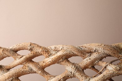 Photo of Presentation for product. Braided tree trunk on beige background