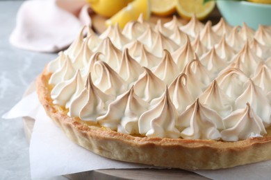 Photo of Delicious lemon meringue pie on grey table, closeup