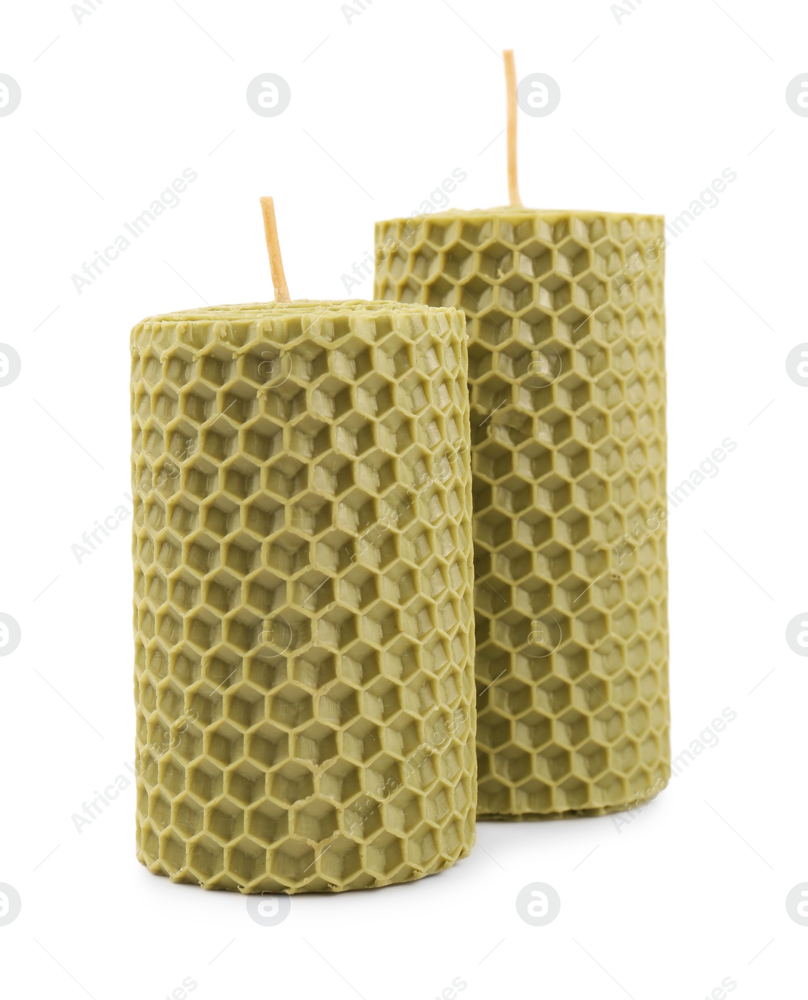 Photo of Stylish elegant beeswax candles isolated on white