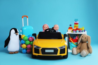 Photo of Child's electric car with other toys on light blue background