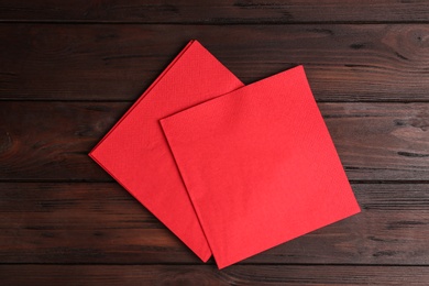 Clean napkins on wooden table, flat lay