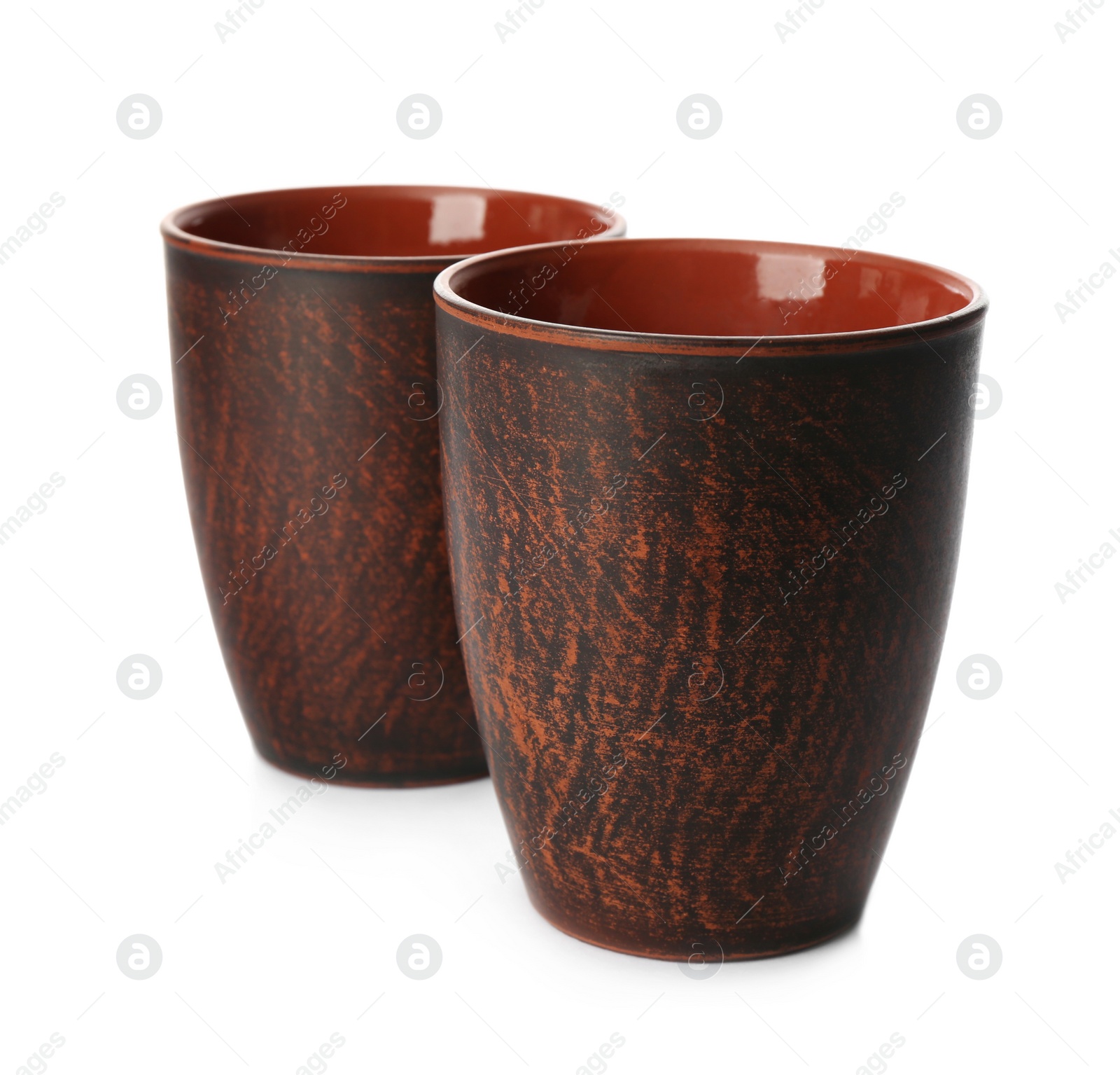 Photo of Stylish brown clay cups on white background