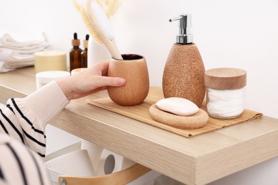 Photo of Bath accessories. Woman with holder of brush indoors, closeup