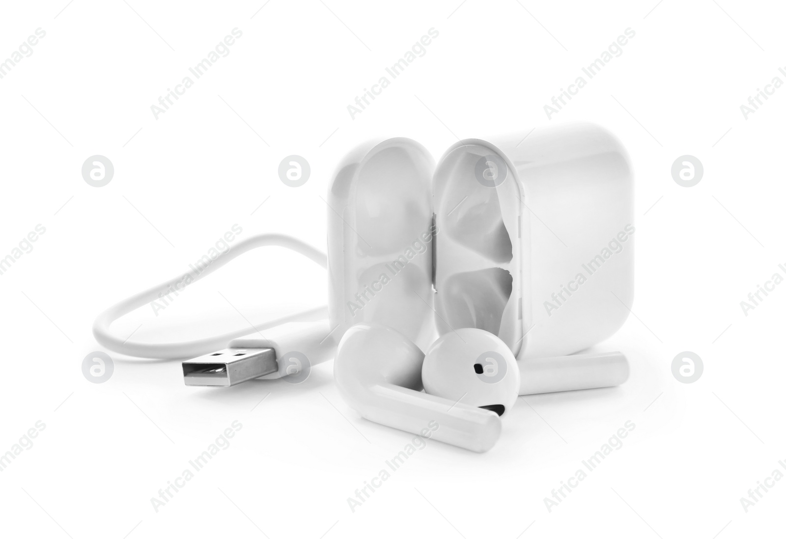 Photo of Modern wireless earphones, charging case and cable on white background