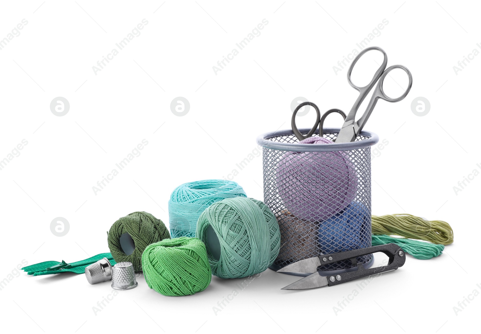 Photo of Color threads and sewing accessories on white background