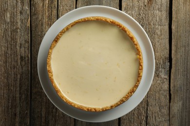 Photo of Tasty vegan tofu cheesecake on wooden table, top view