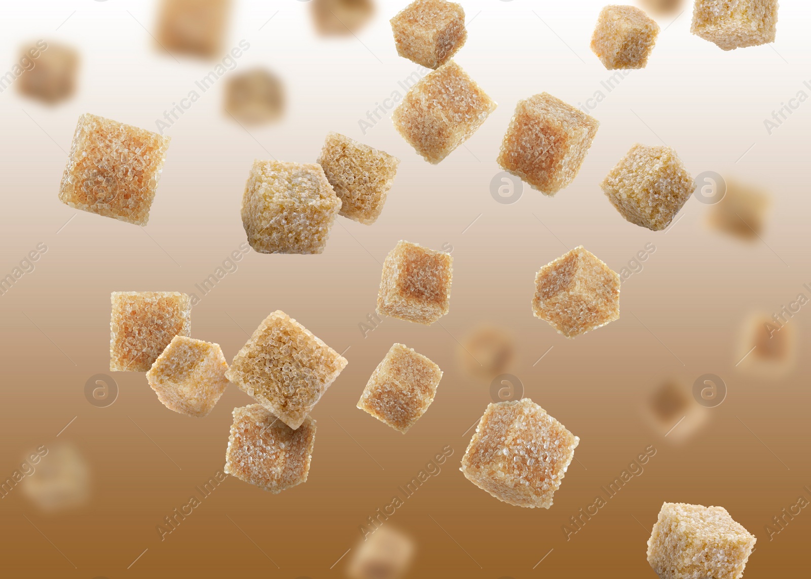 Image of Brown cane sugar cubes falling on brown gradient background