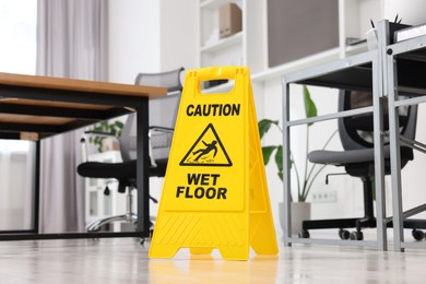 Cleaning service. Wet floor sign in office