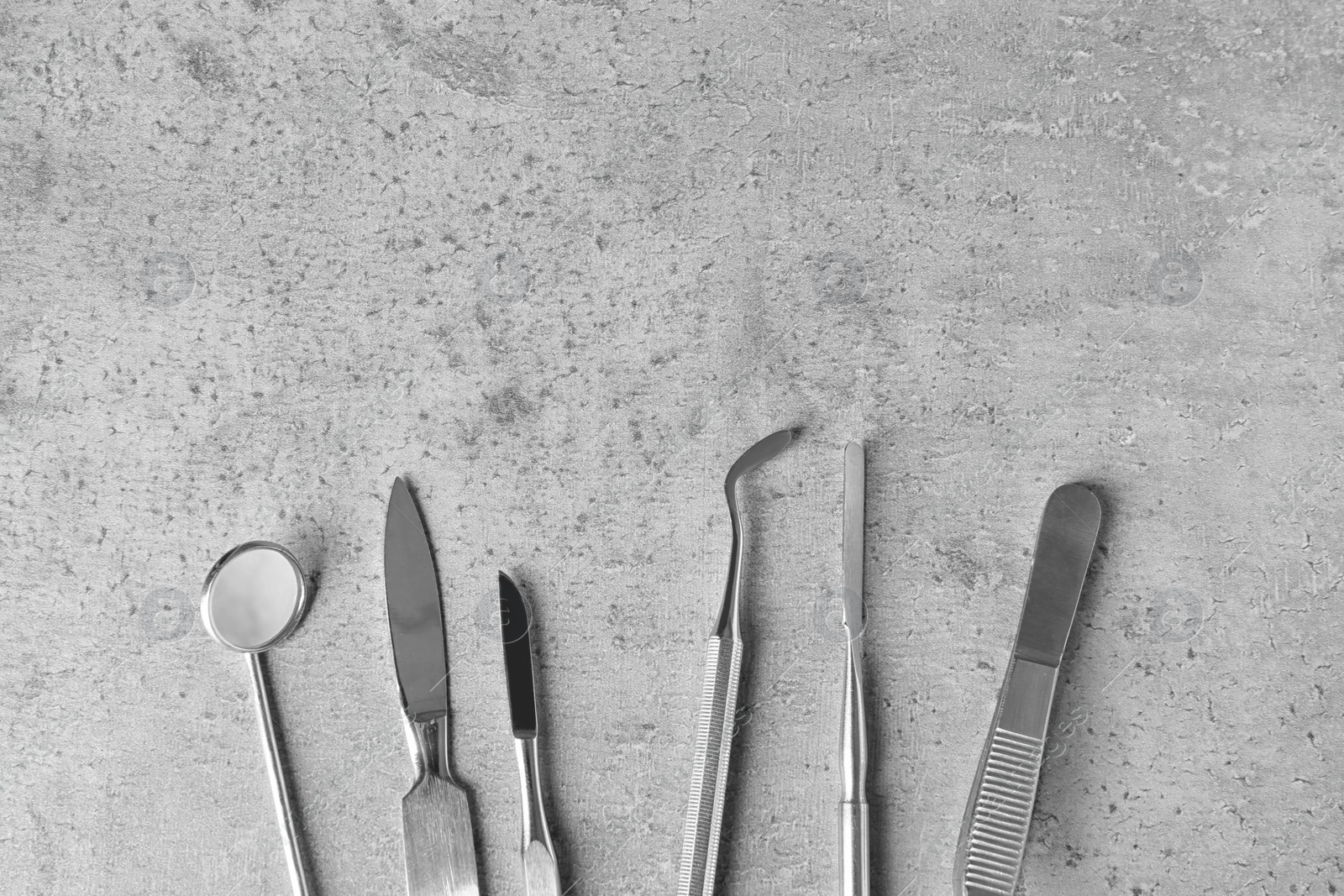 Photo of Professional dental tools and space for text on grey background, flat lay. Mouth and teeth care