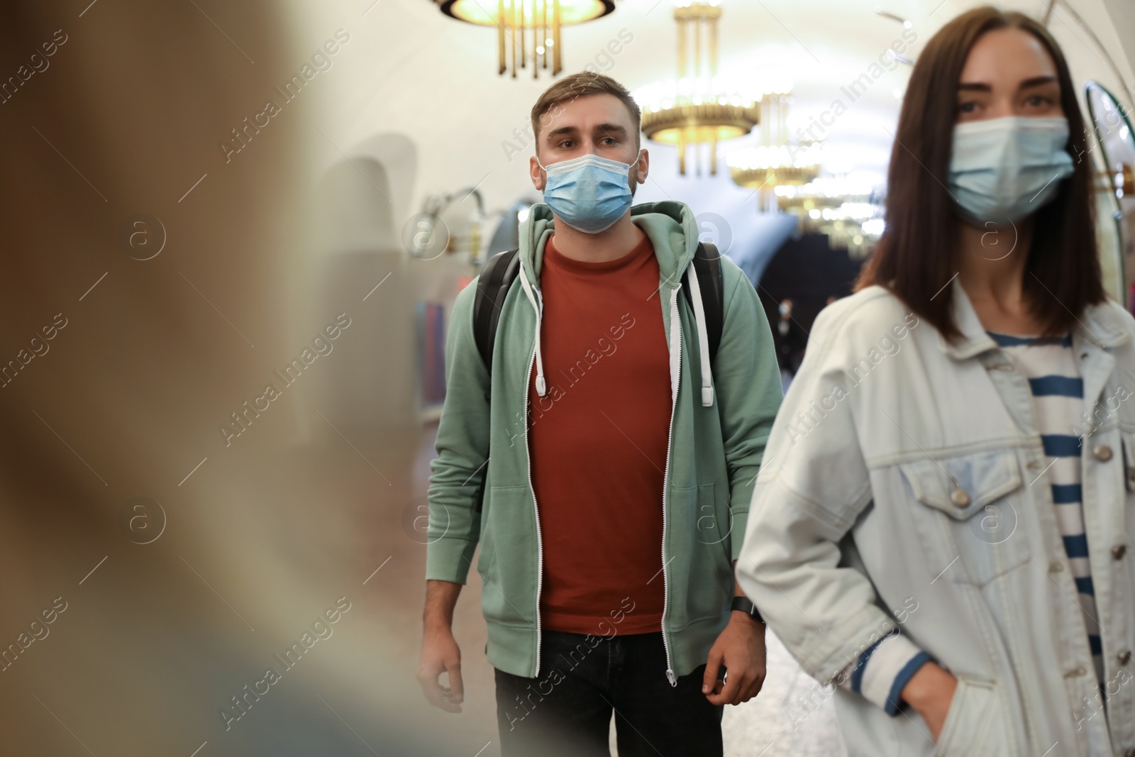 Photo of People in protective masks at subway station. Public transport