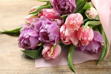 Beautiful bouquet of colorful tulip flowers on wooden table