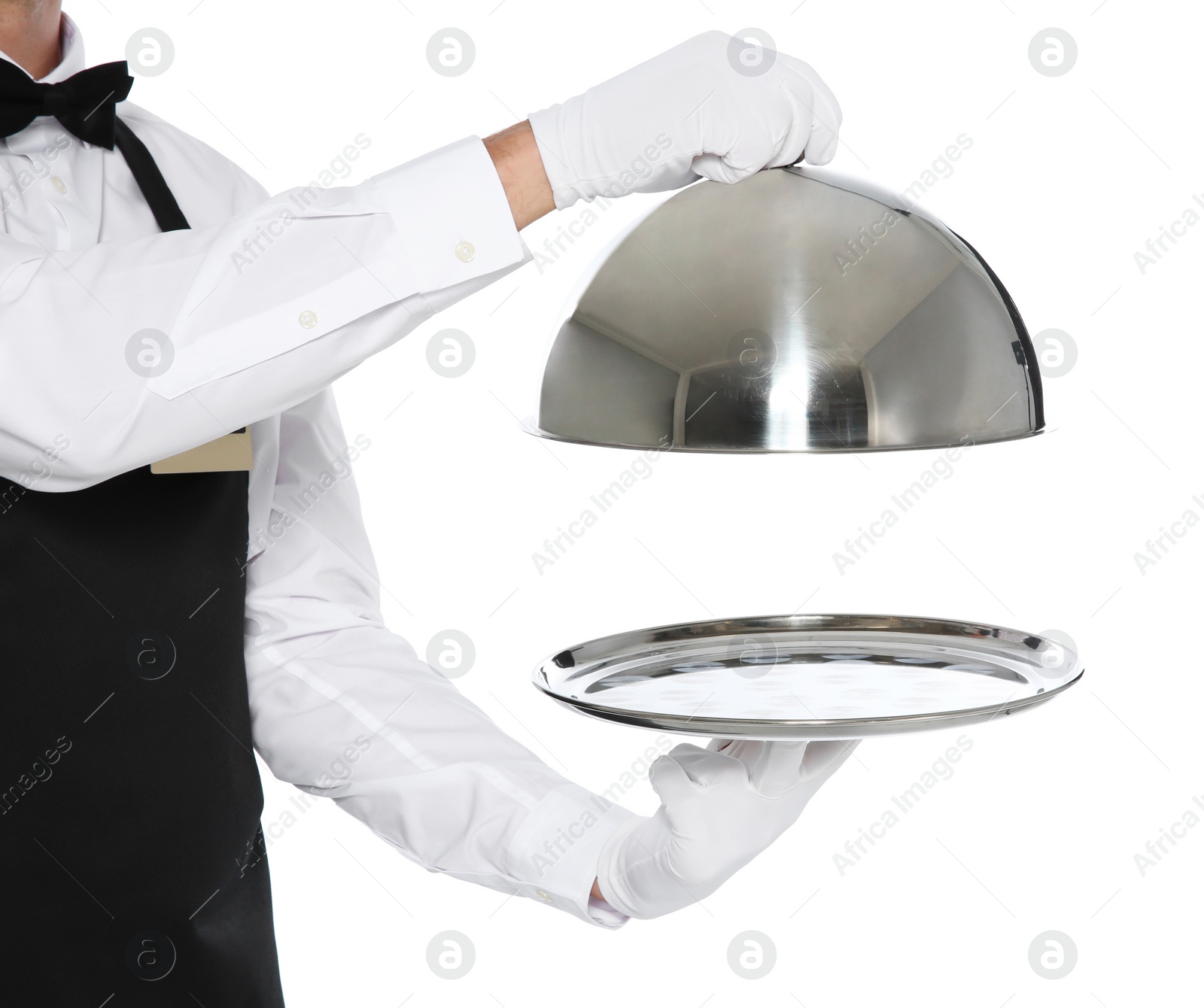 Photo of Young waiter holding metal tray with lid on white background