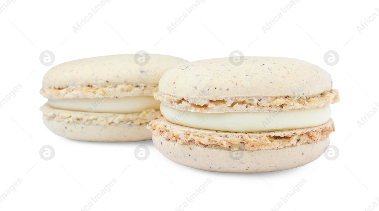 Photo of Beige macarons on white background. Delicious dessert