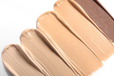 Samples of skin foundation on white background, closeup