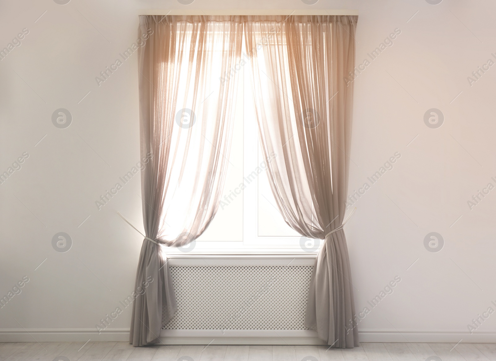 Photo of Window with beautiful curtains in empty room