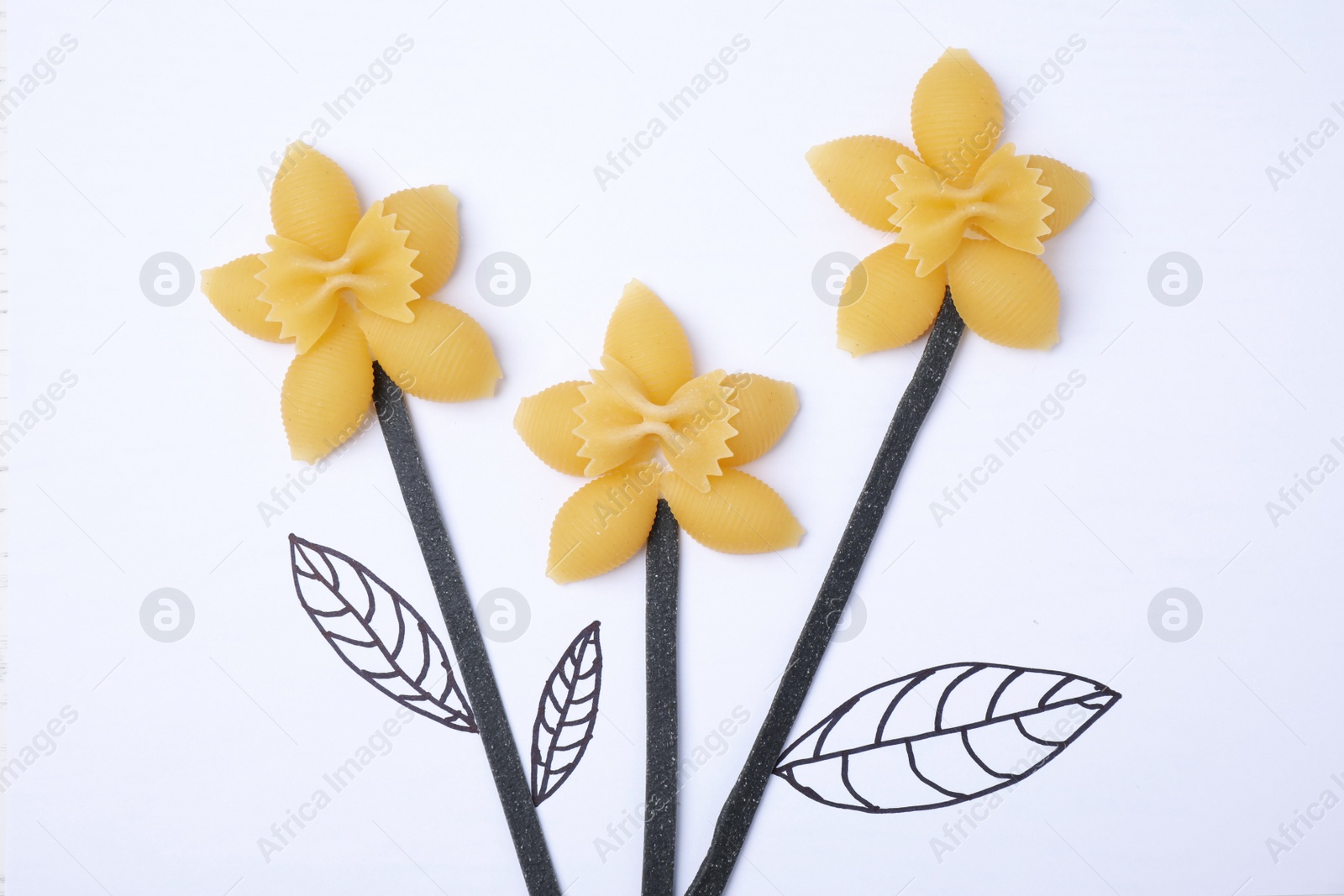 Photo of Flowers made with pasta on white background, top view