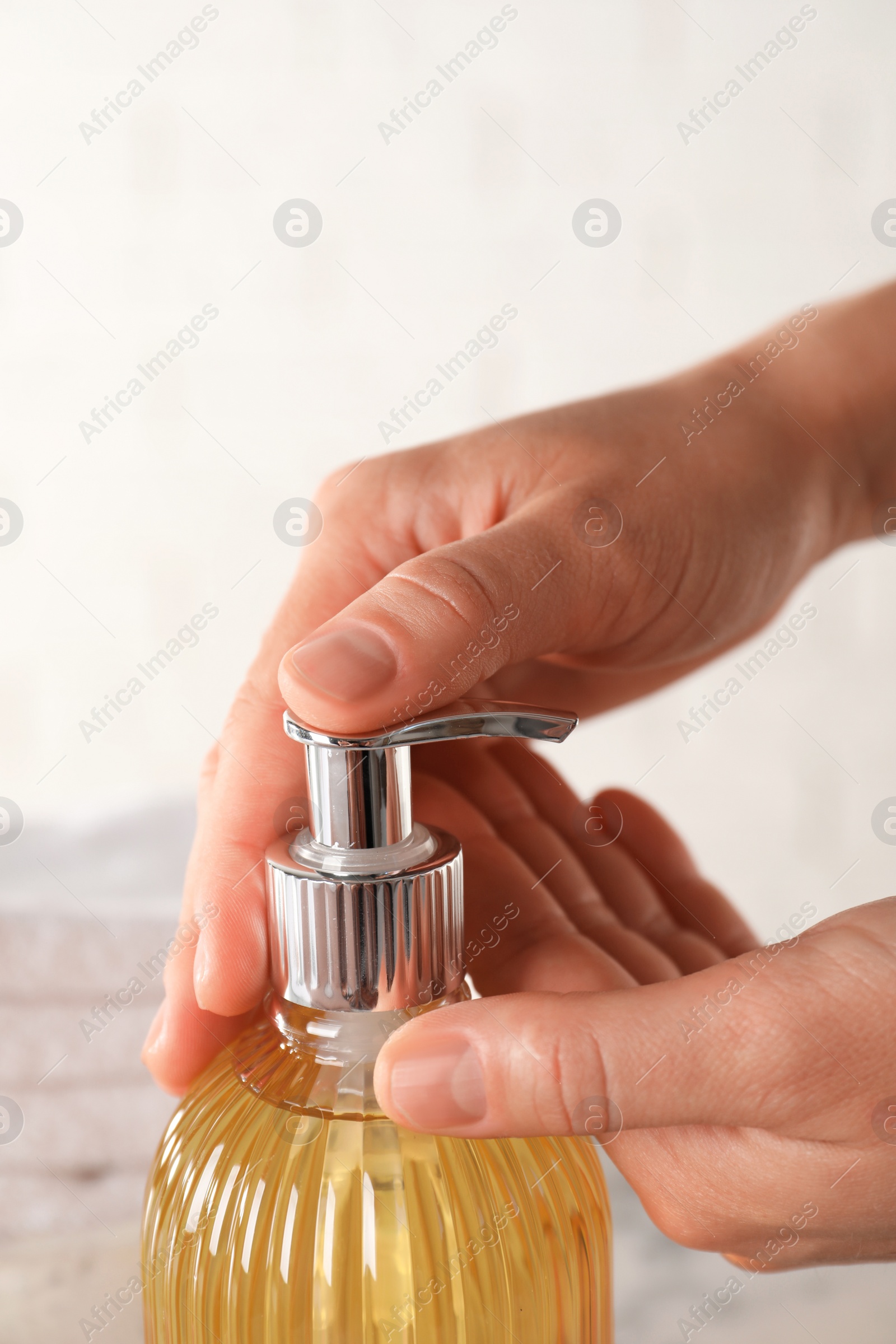 Photo of Woman using liquid soap dispenser, closeup view