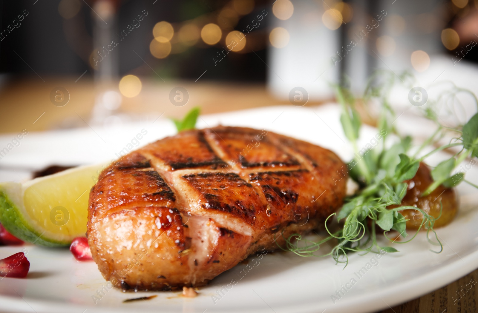 Photo of Delicious grilled duck breast with lime on plate, closeup