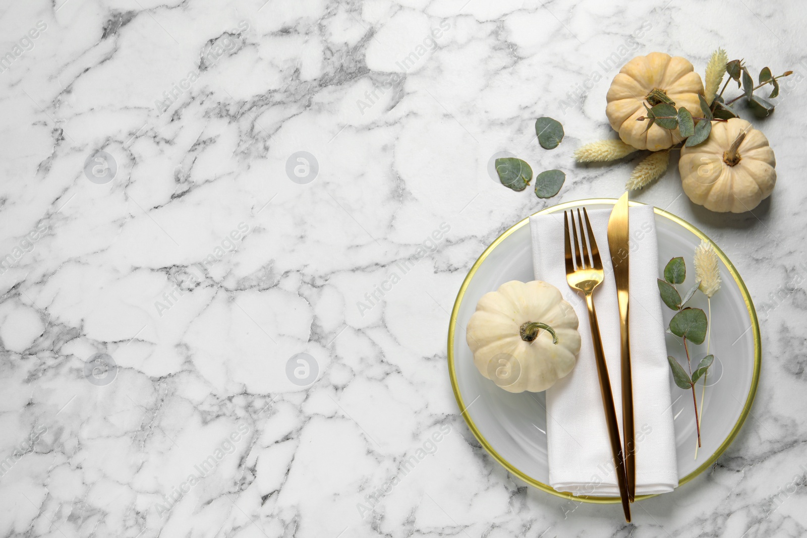 Photo of Festive table setting with autumn decor on white marble background, flat lay. Space for text