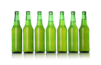 Photo of Green bottles with beer isolated on white