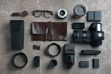 Flat lay composition with photographer's equipment and accessories on grey background