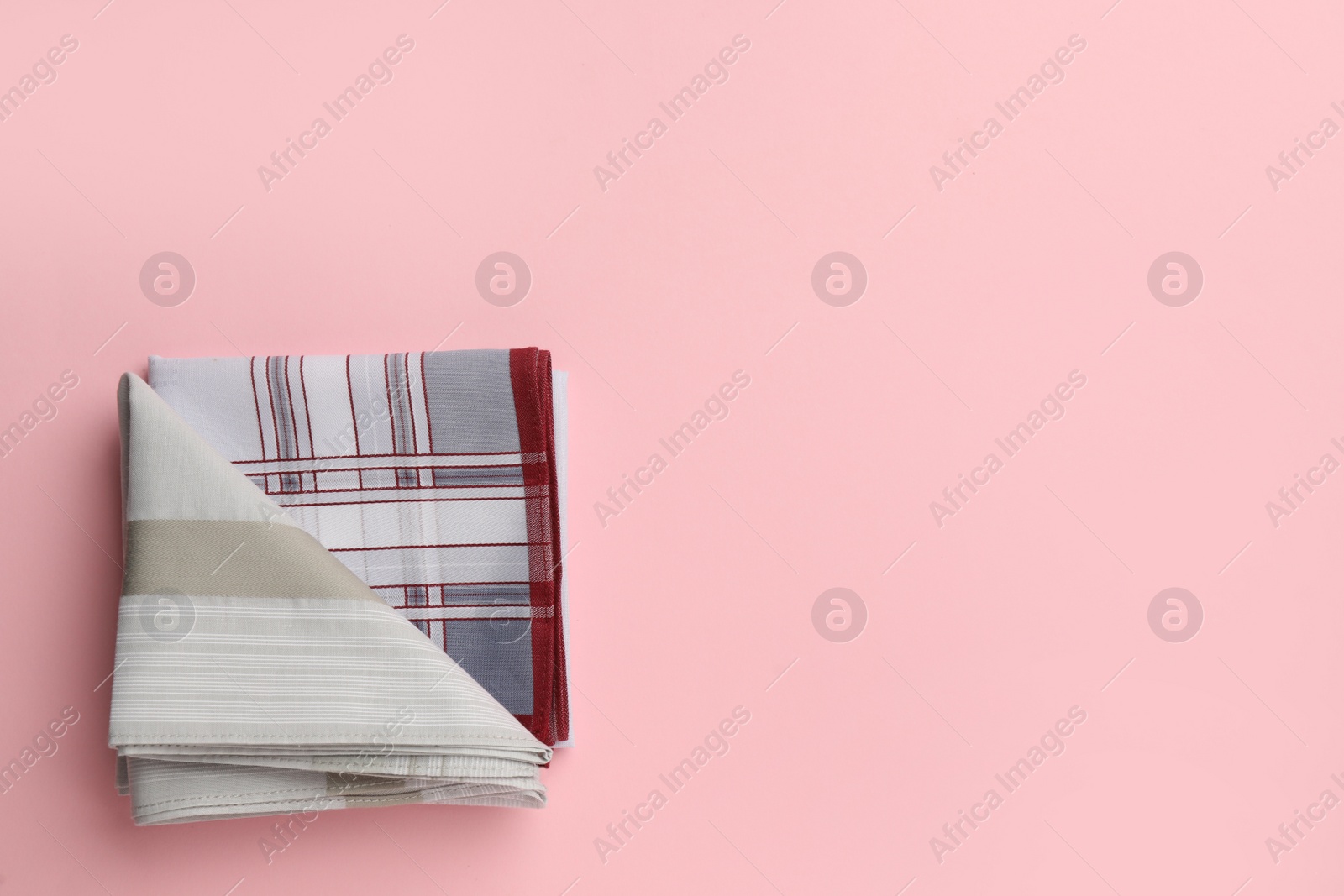 Photo of Stylish handkerchiefs on pink background, top view. Space for text