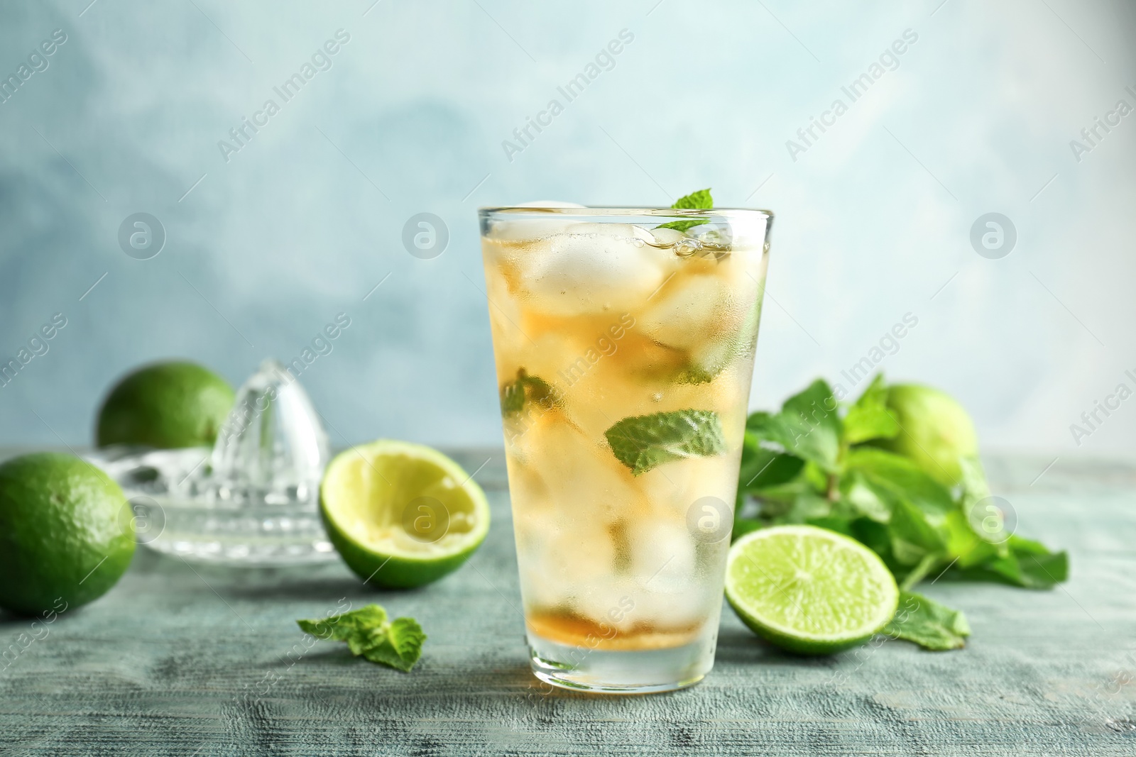 Photo of Composition with delicious mint julep cocktail on table