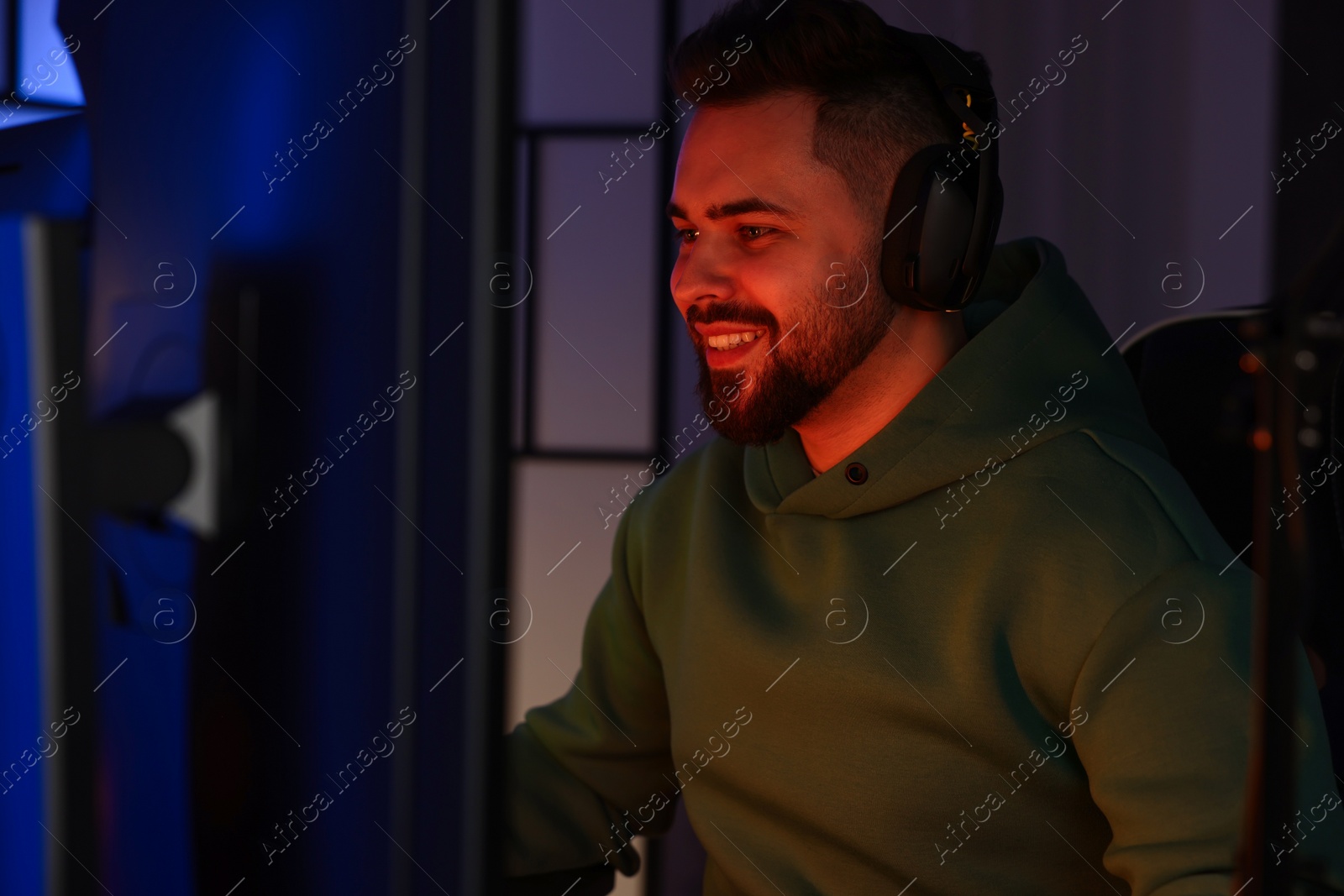 Photo of Man playing video games on computer indoors