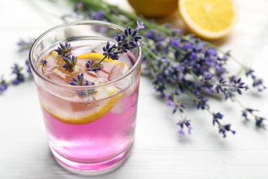 Photo of Fresh delicious lemonade with lavender on white wooden table, closeup. Space for text