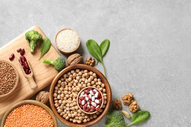 Set of natural food high in protein and space for text on grey background, top view