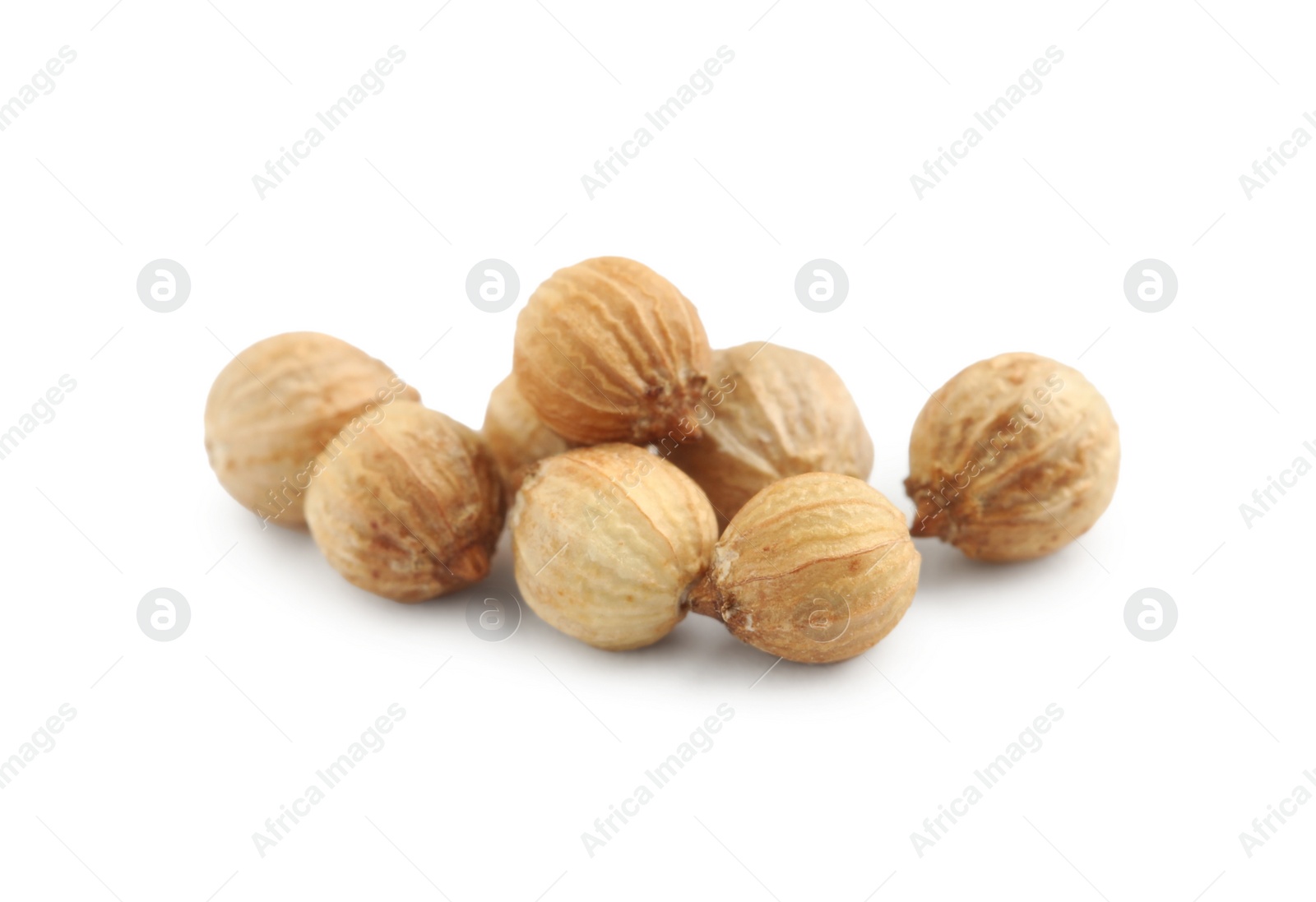 Photo of Heap of dried coriander seeds on white background, closeup