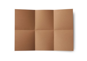 Photo of Folded kraft paper sheet isolated on white, top view