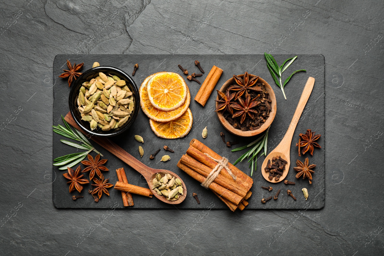 Photo of Flat lay composition with mulled wine ingredients on black slate table