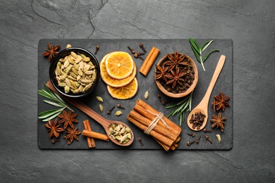 Flat lay composition with mulled wine ingredients on black slate table