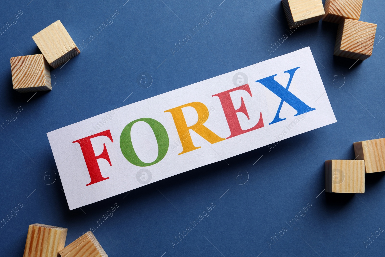 Photo of Sheet of paper with word Forex and cubes on dark blue background, flat lay