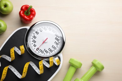 Photo of Flat lay composition with bathroom scale and measuring tape on wooden floor, space for text. Weight loss concept